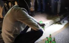 A man in Soweto pours the alcohol he had in his possession during a police operation on Saturday, 06 June 2020, on the  first weekend since the level 3 lockdown which permits the sale of alcohol. Picture: EWN