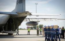 Ukrainian soldiers carry coffins with the remains of victims of the Malaysia Airlines flight MH17 crash to a military plane during a ceremony at the airport of Kharkiv, Ukraine, on 23 July 2014. Picture: AFP.