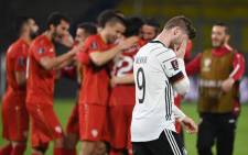 North Macedonia players celebrate a win as Germany forward Timo Werner walks past after their Fifa World Cup Qatar 2022 qualification football match in Duisburg, western Germany on March 31, 2021. Picture: Ina Fassbender/AFP