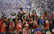 Chilean players celebrate with the trophy of the 2015 Copa America football championship, in Santiago, Chile, on 4 July, 2015. Picture: AFP.