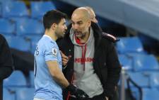 Manchester City manager Pep Guardiola (R) briefs striker Sergio Aguero during the English Premier League football match between Manchester City and Southampton at the Etihad Stadium in Manchester, north west England on March 10, 2021. Picture: Clive Brunskill/AFP