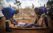 An injured woman is treated after she was injured after two commuter Metro Rail trains collided outside Tembisa. Picture: Thomas Holder/EWN