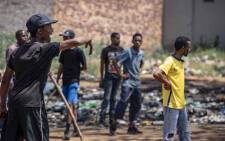 Residents of Reiger Park and Joe Slovo hurl rocks at each other during clashes over illegal power connections. Picture: Thomas Holder/EWN.