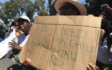 A supporter of the missing child's family holds up a poster outside of court, calling for no bail for Karabo Tau. Tau received bail on 12 February 2020. Picture: Lauren Isaacs/EWN.
