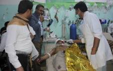 An injured Yemeni man receives medical aid at an emergency room in the Saada province early on 20 November 2018, following a reported air strike. Picture: AFP