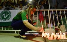 Fans light candles in tribute to the players of Brazilian team Chapecoense Real killed in a plane crash in the Colombian mountains. Picture: AFP.