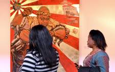 Gallery visitors take cellphone pictures of the painting entitled Umshini Wam by Ayanda Mabulu on 28 August 2012. Picture: Aletta Gardner/EWN.