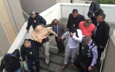 FILE. Three City of Cape Town traffic officials are marched out of the Civic Centre after they were arrested for fraud and corruption on 13 July 2015. Picture: Natalie Malgas/EWN