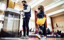 People cast their ballots at a polling station during parliamentary and local elections in Moscow on 18 September 2021. Picture: AFP