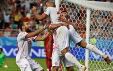 Tunisia's forward Wahbi Khazri (centre) is congratulated by teammates after scoring a goal during the Russia 2018 World Cup Group G football match between Panama and Tunisia at the Mordovia Arena in Saransk on 28 June 2018. Picture: AFP.