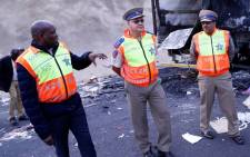 FILE: KwaZulu-Natal MEC for Transport, Community Safety and Liaison Mr Mxolisi Kaunda with Road Traffic Inspectorate (RTI) officials inspecting the area where 18 trucks were set alight at Mooi River Toll Plaza on the N3. Picture: @GovernmentZA/Twitter