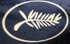 Rain drops on the Palm logo on an official car during the Cannes Film Festival. Picture: AFP.