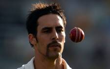 Australia paceman Mitchell Johnson tosses a ball during the first Ashes Test match against England. Source: AFP.