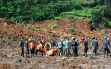 FILE: A rescue team searches for survivors and remove bodies after a landslide at Jemblung village in Banjarnegara, Central Java province, on 13 December, 2014. Picture: AFP.