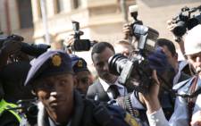 FILE. Oscar Pistorius walks the media gauntlet outside the High Court in Pretoria ahead of his sentencing on 13 October 2014. Picture: Christa Eybers/EWN.
