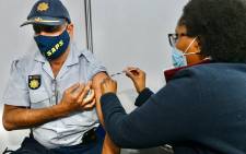 A police officer gets his COVID-19 vaccine at the Orlando Stadium in Soweto on 5 July 2021. Picture: @GautengProvince/Twitter
