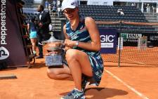 Poland's Iga Swiatek poses with the winner's trophy after defeating Tunisia's Ons Jabeur to win the final of the Women's WTA Rome Open tennis tournament on May 15, 2022 at Foro Italico in Rome. Picture: Tiziana FABI / AFP