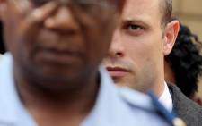 Oscar Pistorius leaves the High Court in Pretoria after day five of his murder trial on 7 March 2014. Picture: Sebabatso Mosamo/EWN.