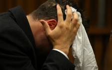 Oscar Pistorius reacts in the dock during his murder trial at the High Court in Pretoria on 10 March 2014. Picture: Pool.