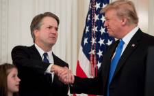 US Judge Brett Kavanaugh shakes hands with US President Donald Trump after being nominated to the Supreme Court in the East Room of the White House on 9 July, 2018 in Washington, DC. Picture: AFP