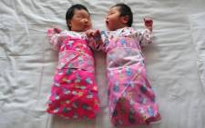 FILE: Newborn babies lie on a hospital bed in Beijing, China. Picture: AFP