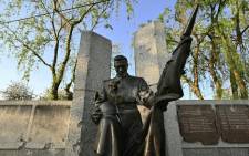 A damaged bronze sculpture of a soldier kneeling to pay his last respect to fallen comrades in WWII is seen on the eve of victory day in Kyiv province on May 8, 2022. Picture: AFP