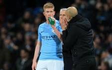 FILE: Manchester City midfielder Kevin De Bruyne (L) takes a drink as Manchester City's manager Pep Guardiola (R) gives instructions during the English Premier League football match on 31 January 2018. Picture: AFP