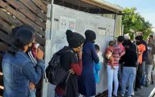 FILE: Hungry residents queue outside the Tafelsig Mitchells Plain CAN initiative. Picture: Tafelsig Mitchells Plain CAN/Facebook