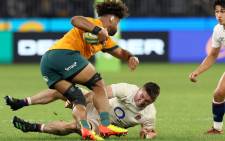 Rob Valetini of Australia (foreground) avoids a tackle by Tom Curry of England (bottom) during the rugby test between Australia and England at the Optus Stadium in Perth on 2 July 2022. Picture: Trevor Collens/AFP