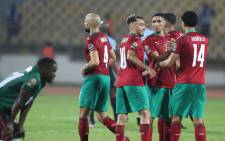 Morocco's players celebrate their victory and qualification for next round at the end of the Africa Cup of Nations (CAN) 2021 round of 16 football match between Morocco and Malawi at Stade Ahmadou-Ahidjo in Yaounde on 25 January 2022. Picture: Kenzo Tribouillard/AFP