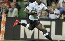 Sharks winger Lwazi Mvovo races to score a try against the Rebels during their Super Rugby match in Melbourne on March 11, 2011. Picture: AFP