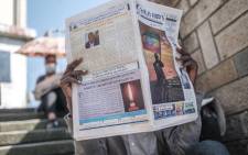 A man holds a newspaper in a downtown area of the city of Addis Ababa, Ethiopia, on November 3, 2021. Ethiopia's cabinet on November 2, 2021 declared a nationwide state of emergency after Tigrayan rebels seized two crucial towns in an apparent push towards the capital, state-affiliated media reported. Eduardo Soteras/AFP