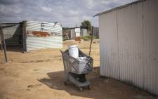 Buckets used to collect water from a tank are seen inside a shopping cart in an informal settlement in Hammanskraal on 23 May 2023. Picture: Michele Spatari/AFP
