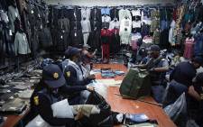 Members of the South African Police Service (SAPS) raided shops in the Johannesburg CBD on 7 August 2019 and confiscated counterfeit goods as part of an operation. Picture: Sifiso Zulu/EWN.
