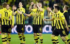 Borussia Dortmund players celebrate after their 4-1 win over Real Madrid in their first leg semifinal of the UEFA Champions League on 24 April 2013. Picture: AFP