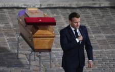 French President Emmanuel Macron pays his respects at the coffin of Samuel Paty's coffin inside Sorbonne University's courtyard in Paris on 21 October 2020, during a national homage to French teacher Samuel Paty, who was beheaded for showing cartoons of the Prophet Muhammad in his civics class. Picture: AFP