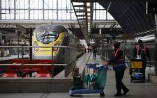 FILE: Workers clean the platform area as a Eurostar train bound for Paris prepares to leave St Pancras International train station in London on 18 January 2021. Picture: Tolga Akmen/AFP
