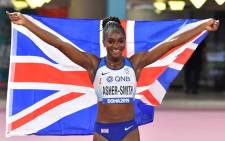 Britain's Dina Asher-Smith celebrates after winning the Women's 200m final at the 2019 IAAF Athletics World Championships at the Khalifa International stadium in Doha on 2 October 2019. Picture: AFP.
