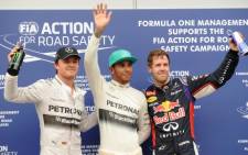 Mercedes driver Lewis Hamilton of Britain (C), Red Bull driver Sebastian Vettel of Germany (R) and Mercedes driver Nico Rosberg of Germany (L) on the podium at the Bahrain Grand Prix. Picture:AFP.
