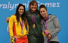 Spain's silver medallist Sarai Gascon, South Africa's gold medallist Natalie du Toit and US bronze medallist Elizabeth Stone during the victory ceremony for the women's 100m backstroke on 30 August. Picture:  AFP/ BEN STANSALL