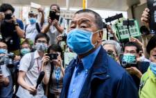 , Hong Kong media tycoon and founder of the Apple Daily newspaper Jimmy Lai (C) arrives at the West Kowloon Magistrates Court for charges related to last year's protests in Hong Kong. Picture: AFP