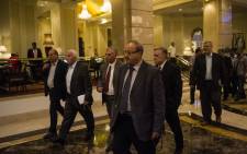 Head of the Palestinian delegation Azzam al-Ahmed (2L) and others members of the delegation arrive at the hotel after a meeting with Egyptian senior intelligence in Cairo on 11 August, 2014. Picture: AFP.