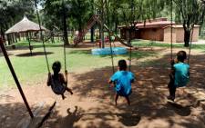 Children enjoying the swings on a playground. Picture: Werner Beukes/SAPA