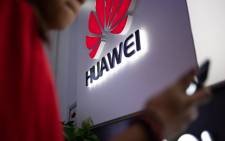 FILE: A Huawei logo is displayed at a retail store. Picture: AFP