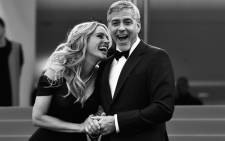 US actress Julia Roberts laughs on 12 May 2016 with US actor George Clooney as they arrive for the screening of the film “Money Monster” at the 69th Cannes Film Festival in Cannes, southern France. Picture: AFP/LOIC VENANCE
