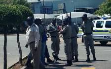 Home Affairs’ immigration officials are seen outside ANN7 offices in Midrand, Johannesburg. Picture: Pelani Phakgadi/EWN.
