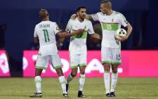 FILE: Algeria's forward Riyad Mahrez (C) celebrates with teammates Yacine Brahimi (R) Islam Slimani after scoring a goal. Picture: AFP