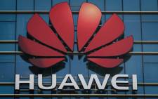 The Huawei logo stands on a Huawei office building in Dongguan in China’s southern Guangdong province on 18 December 2018. Picture: AFP