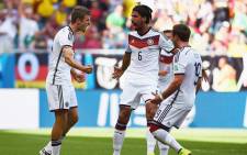 Thomas Mueller celebrates with his team mates after scoring his third goal against Portugal during the opening match in their group. Picture: Fifa.com