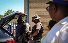 Minister of Police Bheki Cele arrived at Sophiatown SAPS escorted by Presidential Protection Service as the crowd continued to protest outside the gate. Picture: Thomas Holder/EWN